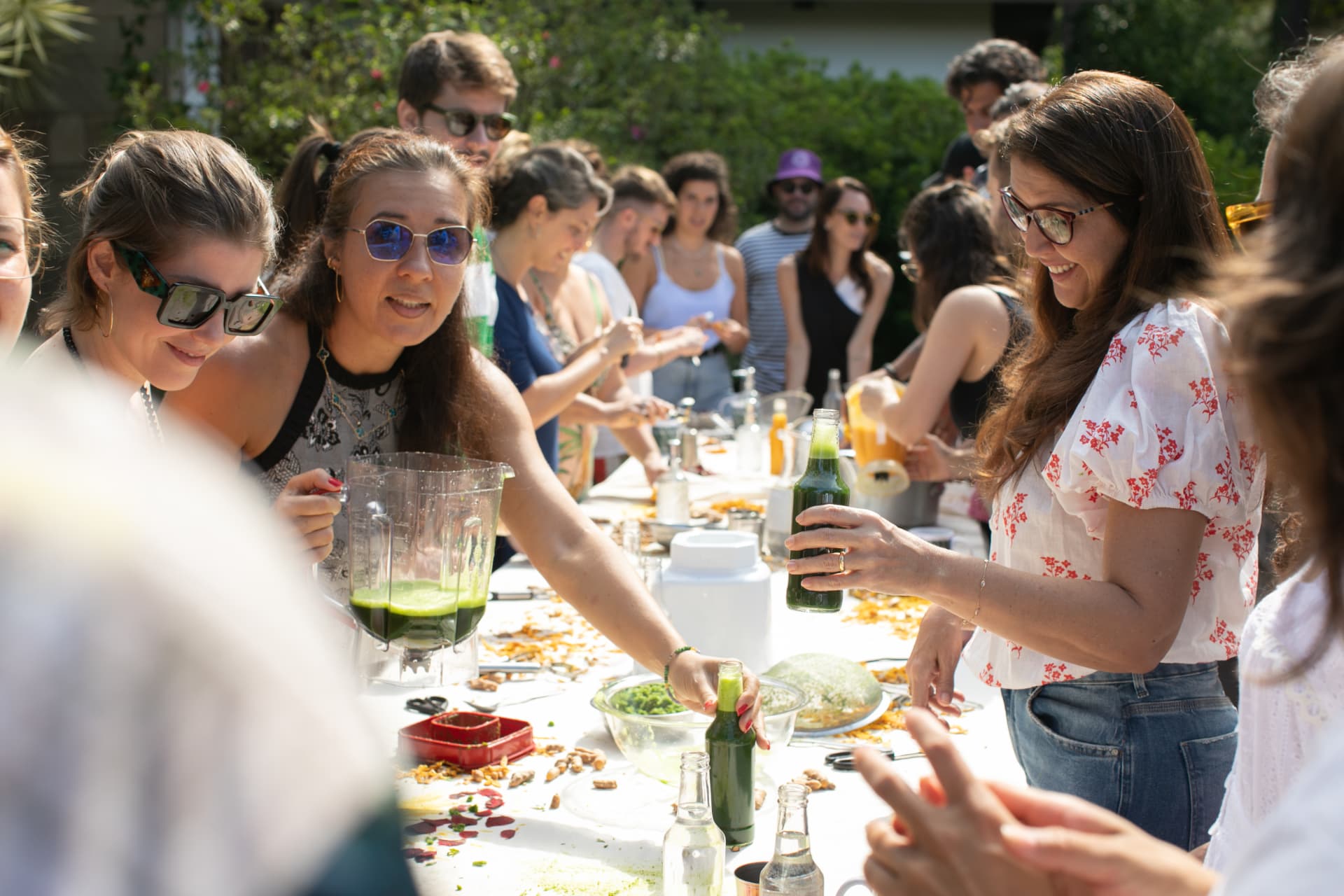 A group of people gathered around a long table outdoors